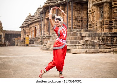 Indian classical odissi dancer at Ananta Basudeva temple with sculptures in  bhubaneswar