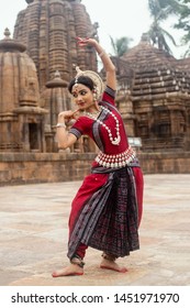 Indian classical odissi Dancer wears traditional costume and posing in front of Mukteshvara Temple,Bhubaneswar, Odisha, India