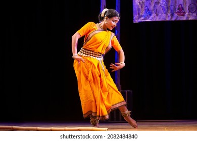 Indian classical odissi dancer wears traditional costume performing dance on stage. Odissi Indian Traditional Dance