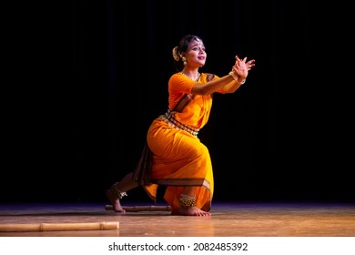 Indian classical odissi dancer wears traditional costume performing dance on stage. Indian Traditional Dance