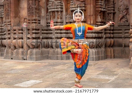Indian classical odissi dancer wears traditional costume posing Mudra or Hand Gestures at Bhrameswar Temple, Bhubaneswar, Odisha, India.Indian dance 
