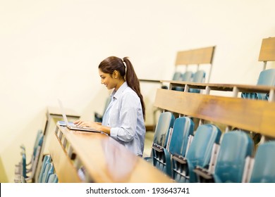 Indian College Student Using Laptop Computer In Lecture Hall