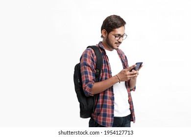 Indian college student using smartphone on white background. - Shutterstock ID 1954127713