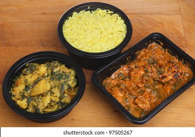 Indian Convenience Food Of Chicken Massala Curry, Saag Aloo And Pliau Rice.