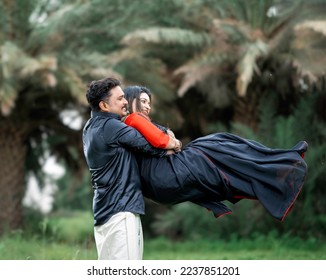 indian couple black dress romance in coconut field - Shutterstock ID 2237851201