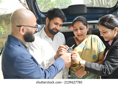 An Indian Couple Buying New Car From The Car Dealer