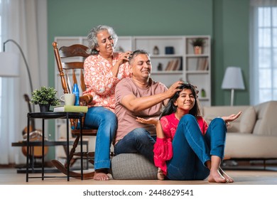 Indian couple and daughter family giving head massage - Powered by Shutterstock