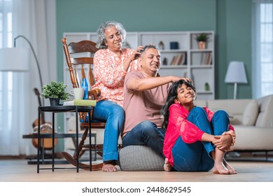 Indian couple and daughter family giving head massage - Powered by Shutterstock