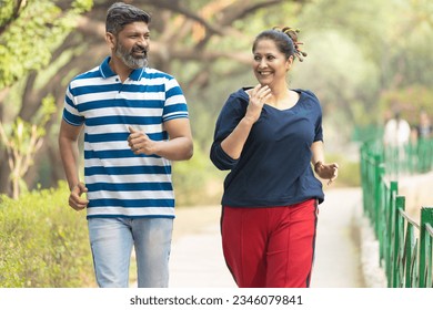 Indian couple doing jogging together at park. - Powered by Shutterstock