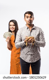 Indian couple holding gold jewelry, ornaments - Asset or Gold Loan concept
