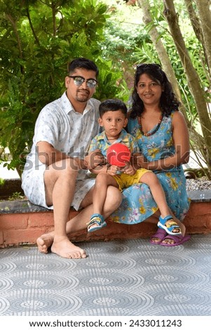 Indian couple with kid posing for photoshoot 