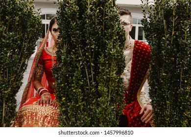 Indian Couple On The Wedding Day Hide In The Park From The Photographer