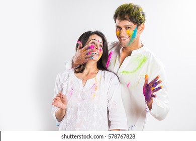 Indian Couple Playing Colours Or People Celebrating Holi, Isolated Over White Background