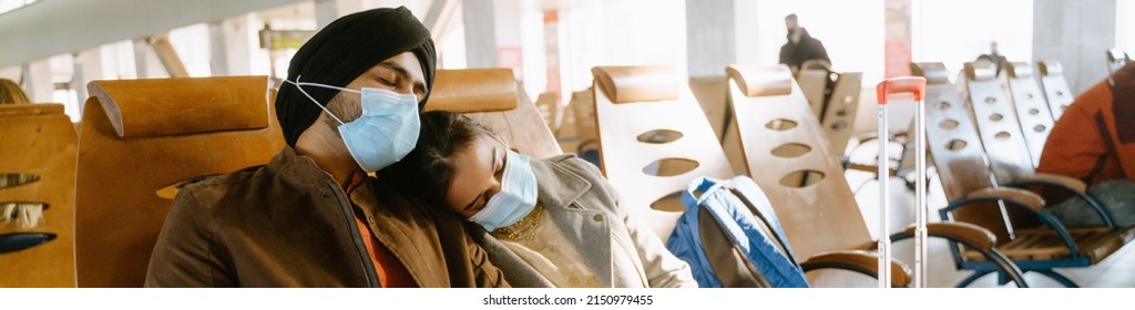 Indian Couple Wearing Face Masks Sleeping While Sitting In Airport Indoors