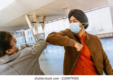 Indian Couple Wearing Face Masks Elbows Bumping In Airport Indoors