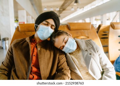 Indian Couple Wearing Face Masks Sleeping While Sitting In Airport Indoors