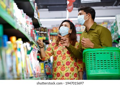 Indian Couple Wearing Protective Face Mask Buying Food In Grocery Store During Virus Epidemic