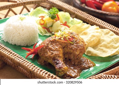 Indian Cuisine Chicken Rendang With Achaar, Rice And Papadum