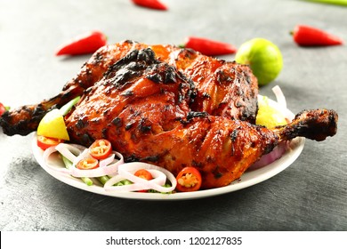 Indian cuisine- delicious tandoori chicken on a vintage table.
