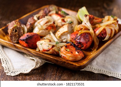 Indian cuisine tandoori oven baked platter of appetizers including malai tikka chicken kebabs shrimp and seekh kebab