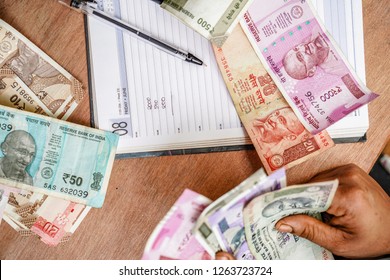 Indian Currency (Rupee) 2000,500,100,50,10,1Rupee. 
 Close Up Of Female Accountant Or Banker Making Calculations