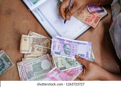 Indian Currency (Rupee) 2000,500,100,50,10,1Rupee. 
 Close Up Of Female Accountant Or Banker Making Calculations