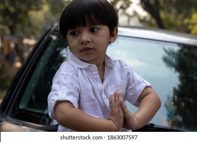 Indian Cute Boy Sitting On Car Bonnet