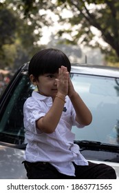 Indian Cute Boy Sitting On Car Bonnet