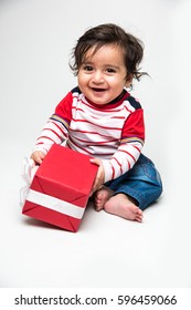  Indian Cute Little Baby /infant Or Toddler Smiling With Gift Box Over White Background