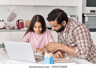Indian Dad Helping School Child Teen Daughter Studying Online At Home. Father And Kid Girl Elearning Having Virtual Class On Laptop, Studying Remote Homeschool On Computer, Doing Homework Together.