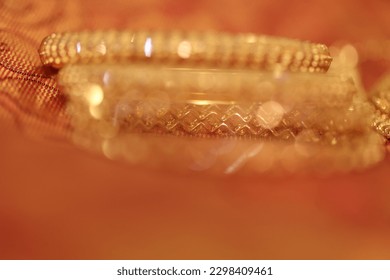 Indian Design Gold Bangle Jewelry blurred backdrop