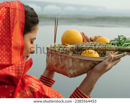 An Indian devotee in traditional attire offers prayers to the sun during the Chhath festival , Asian woman wearing Indian jewelry . An ancient Hindu festival, dedicated to Lord Surya and Chhathi ma...
