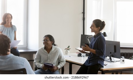 Indian And Diverse Colleagues Communicating In Coworking Space Looking Positive And Optimistic, Discussing Collaborative Project, Take Art In Group Briefing At Workplace. Seminar, Teambuilding