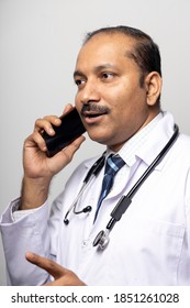 Indian Doctor Doing Online Consultation Using Mobile Phone