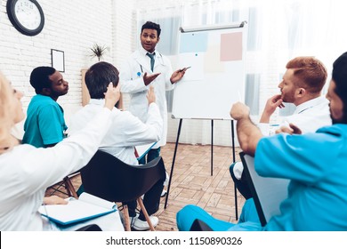 Indian Doctor Shares Experience With Colleagues. Paper Desk Information. Professional Medical Consultation. Multinational Medician Meeting. Teamwork Connection. Clinician Team Group.