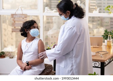 An Indian Doctor Vaccinating A Child Of Above The Age Of 12.