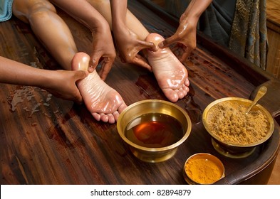   Indian Doctors Doing Traditional Ayurvedic Oil Foot Massage