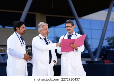 Indian doctors team watching report and discussing at hospital. - Powered by Shutterstock