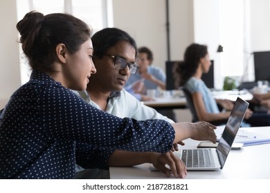 Indian employees discuss on-line project, showing laptop presentation to company client at meeting in coworking office. Business program, platform, software application usage, tech, teamwork concept - Shutterstock ID 2187281821