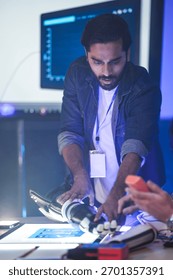 An Indian engineer in an RD lab tests an AI-powered prosthetic arm. The bionic hand has glowing fingertips, showing its advanced sensor technology or system activation.