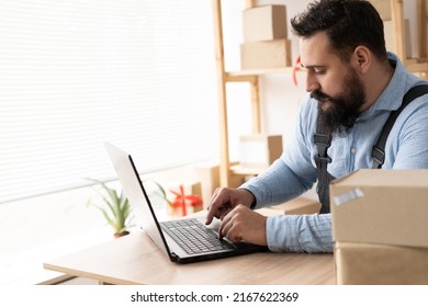 Indian Entrepreneurs Small Business SME Independent Men Work At Home Use Laptops For Commercial Checking, Online Marketing, Packing Boxes, SME Sellers, Concept, E-commerce And Online Sales