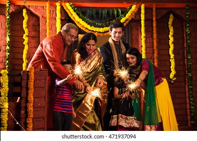 Indian Family Celebrating Diwali Festival With Fire Crackers