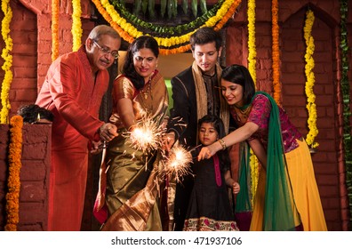 Indian Family Celebrating Diwali Festival With Fire Crackers