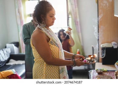 Indian Family Celebrating Hindu Festival At Home - Soft Focus On Mother Face