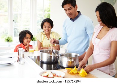 Indian Family Cooking Meal At Home