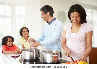 Indian Family Cooking Meal At Home