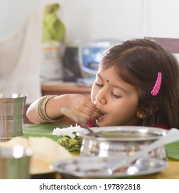 Indian Family Dining At Home. Candid Photo Of Asian Child Self Feeding Rice With Hand. India Culture.