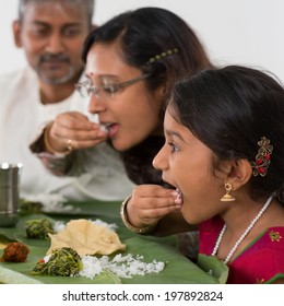 Indian Family Dining At Home. Candid Photo Of Asian People Eating Rice With Hands. India Culture.