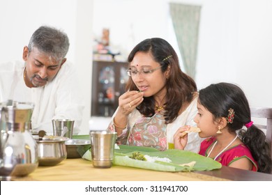 Indian Family Dining At Home. Candid Photo Of India People Eating Rice With Hands. Asian Culture.