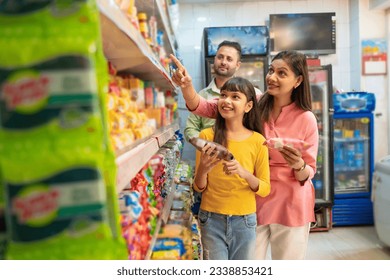 Indian family doing shopping together and choosing product at grocery shop - Powered by Shutterstock